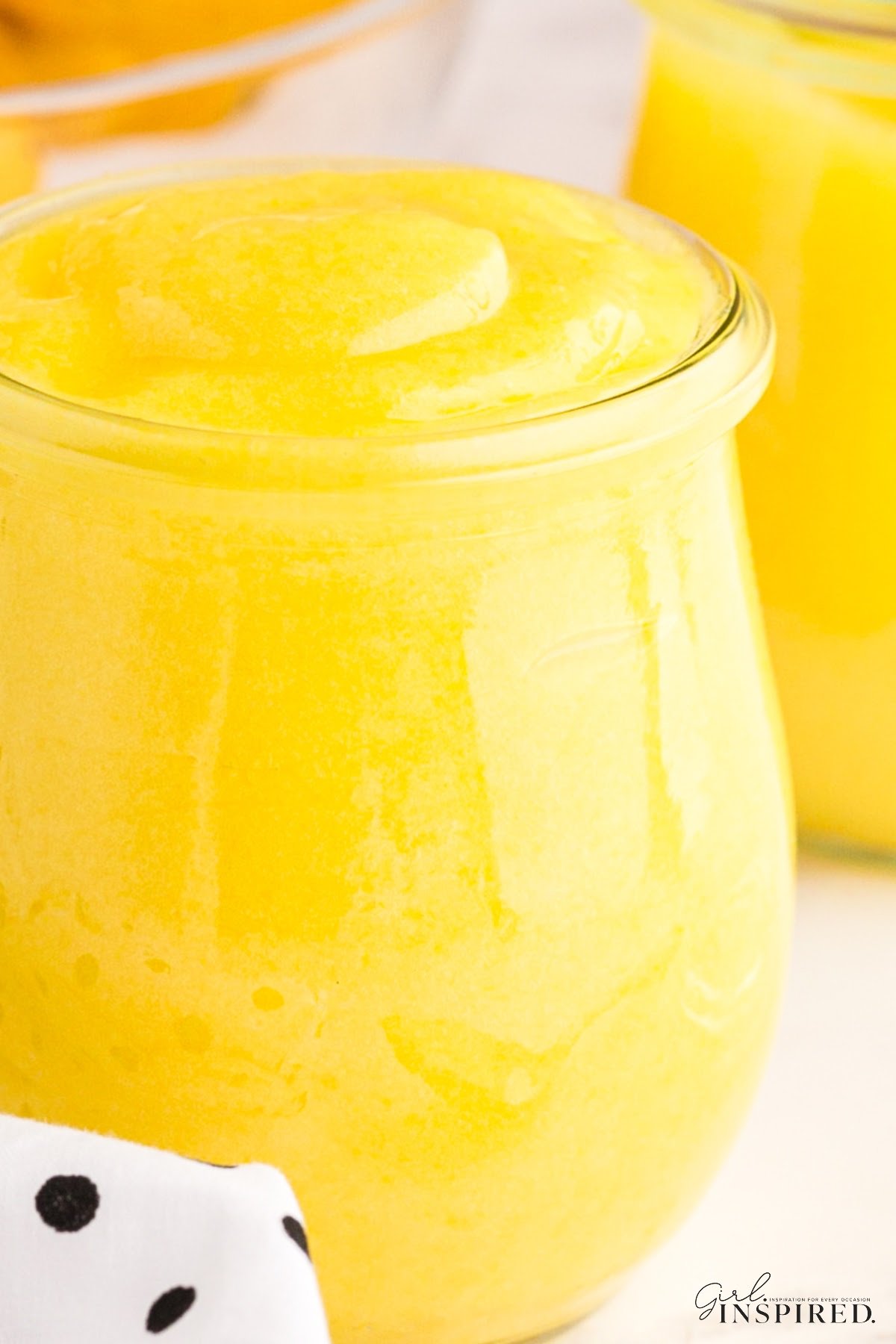 A jar filled with Creamy Lemon Curd.