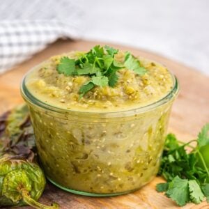 Green Enchilada Sauce in a small glass jar.