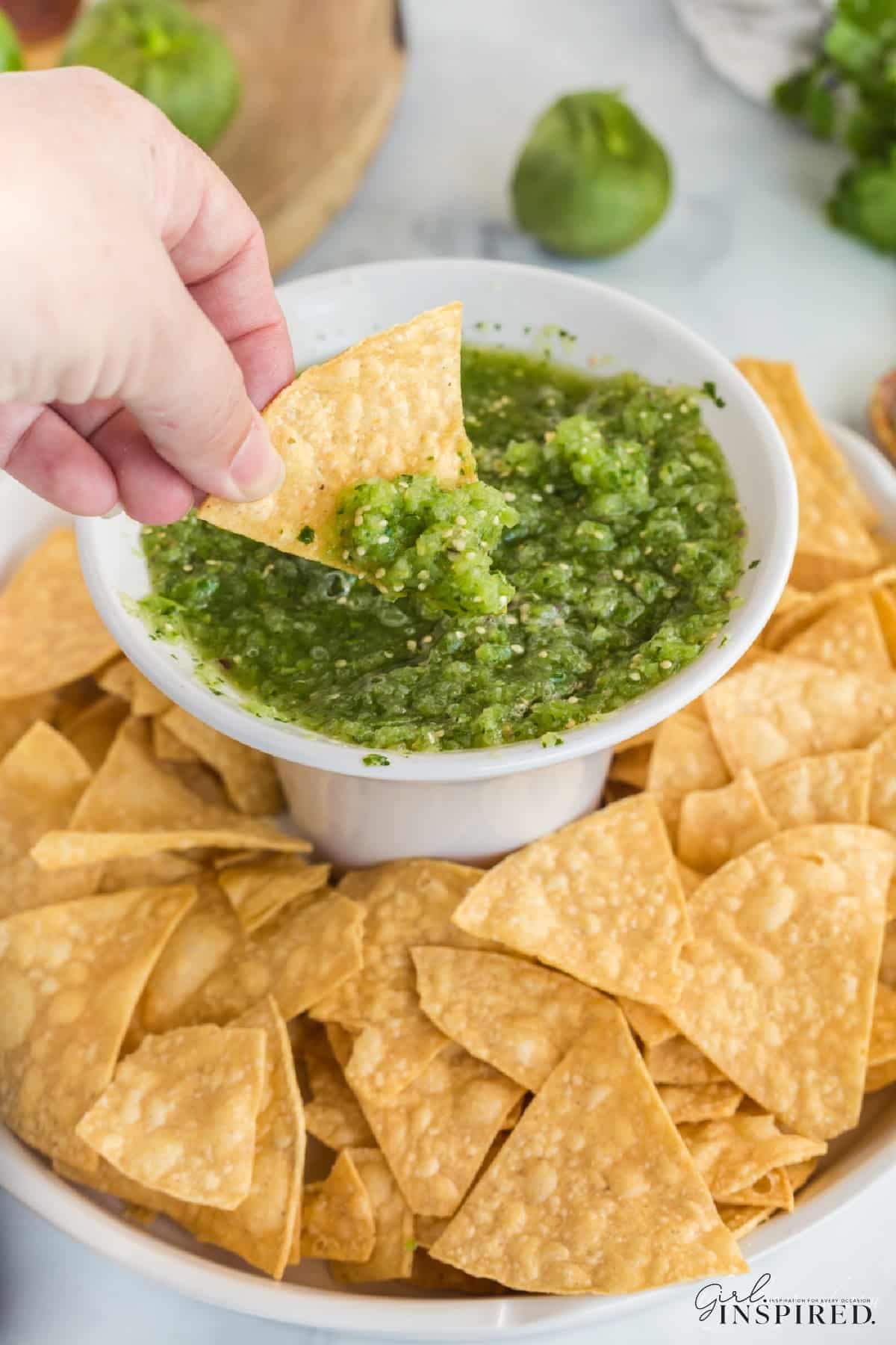 Dipping a tortilla chip in homemade salsa verde.