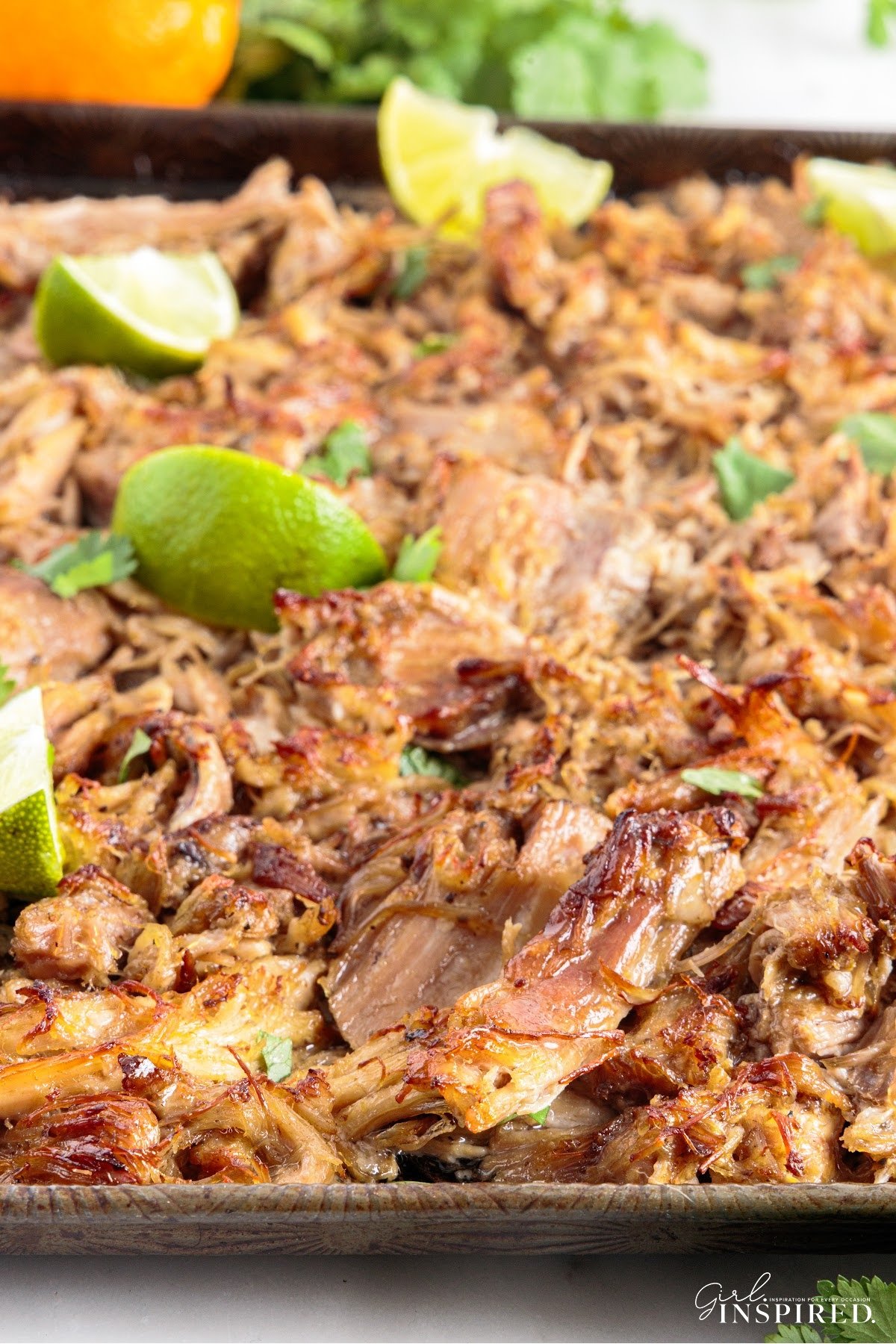 Mojo Pork shredded and ready to eat, garnished with lime,