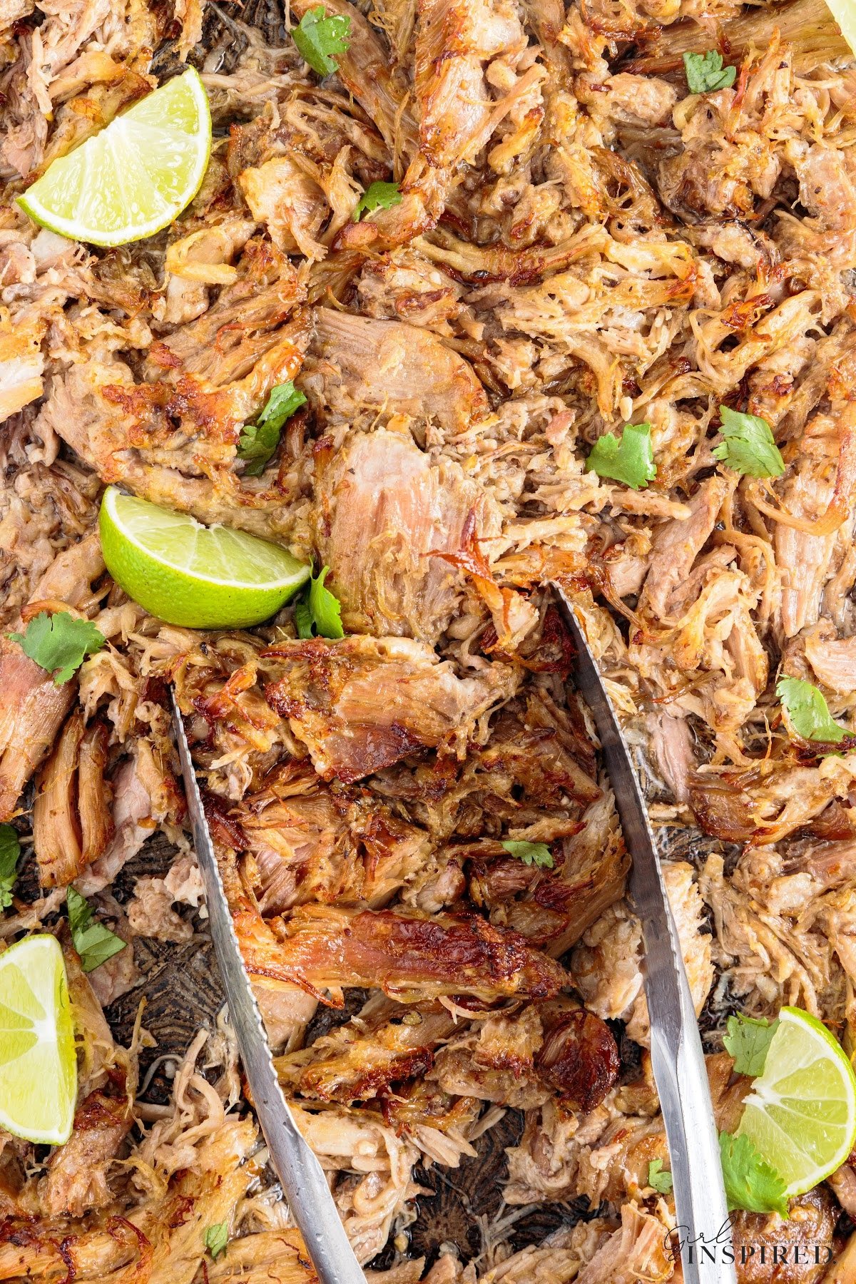 Mojo Pork shredded and ready to eat, garnished with lime,