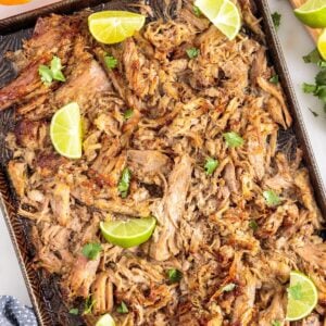 Mojo Pork slow cooker shredded and ready to eat, garnished with lime.