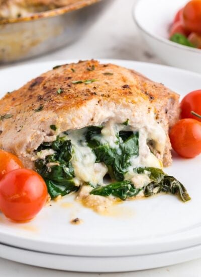 Stuffed Pork Chop on a plate showing the cheese and spinach mixture.