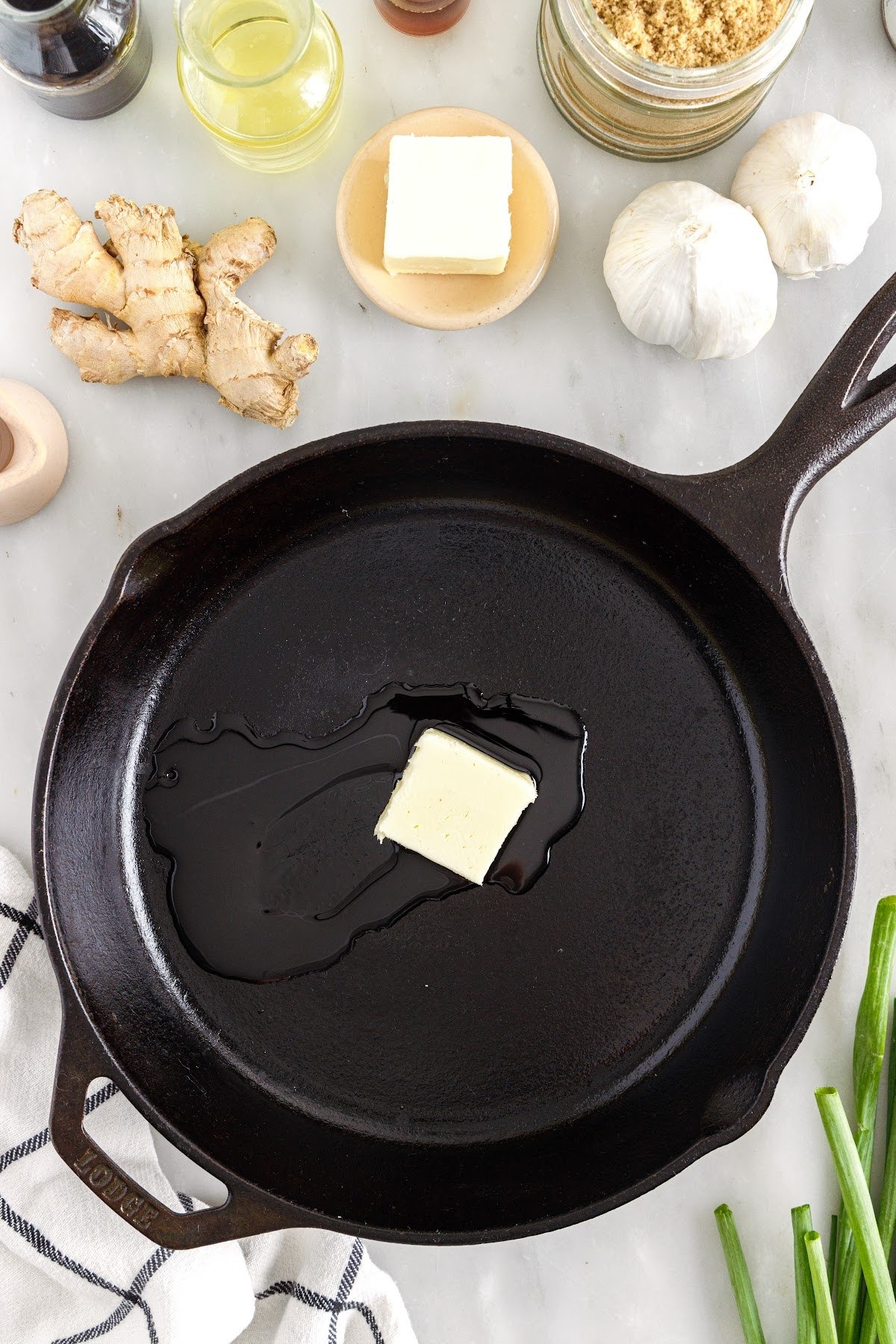 Melting the butter over the skillet.