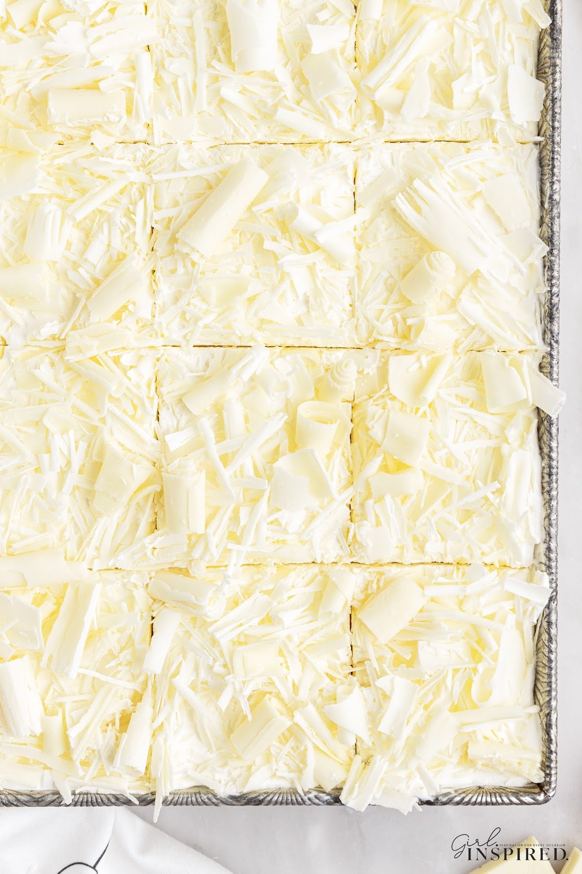 Baking dish of White Chocolate Lasagna cut in squares and ready to serve.
