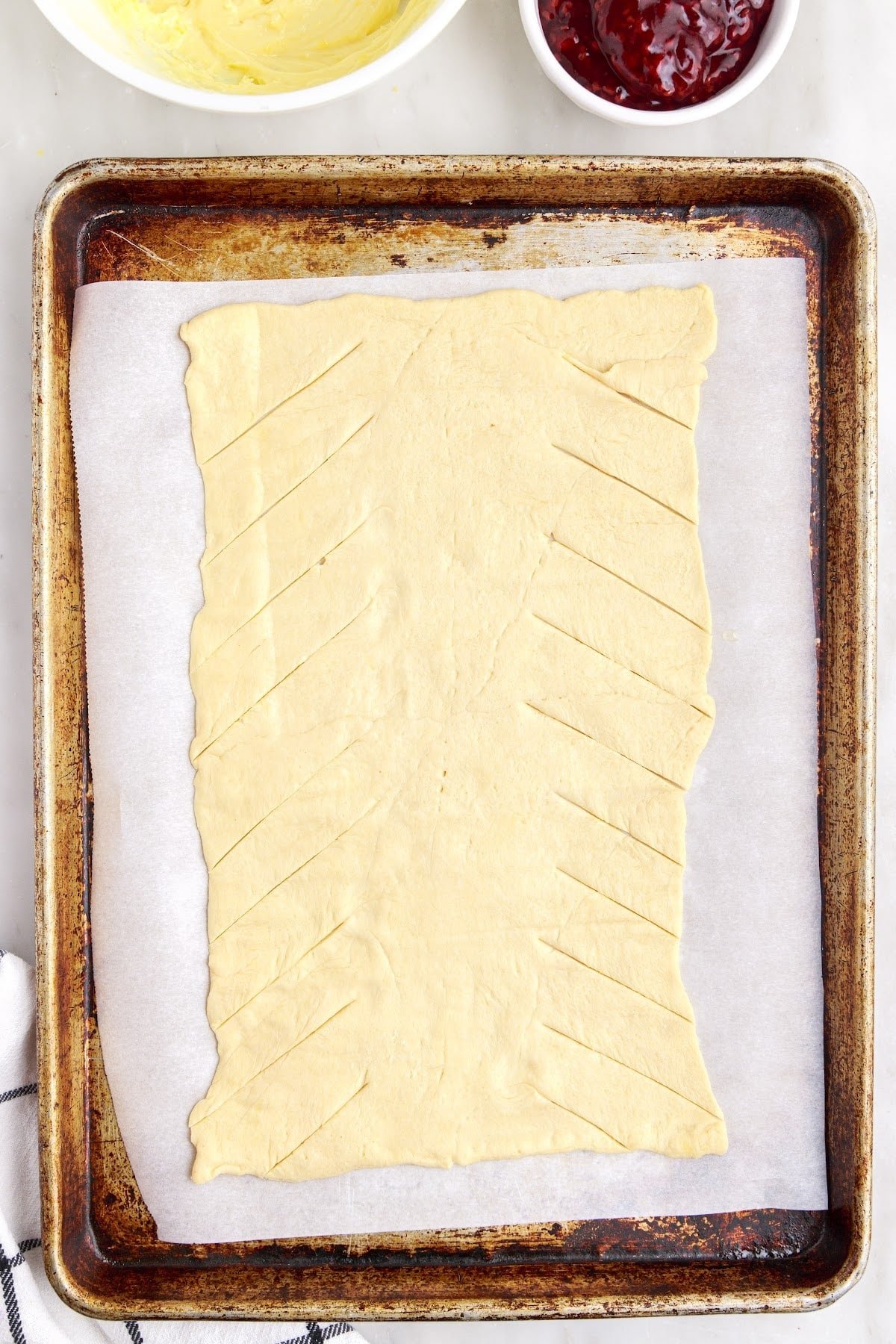 Cutting the edges of the crescent roll dough.