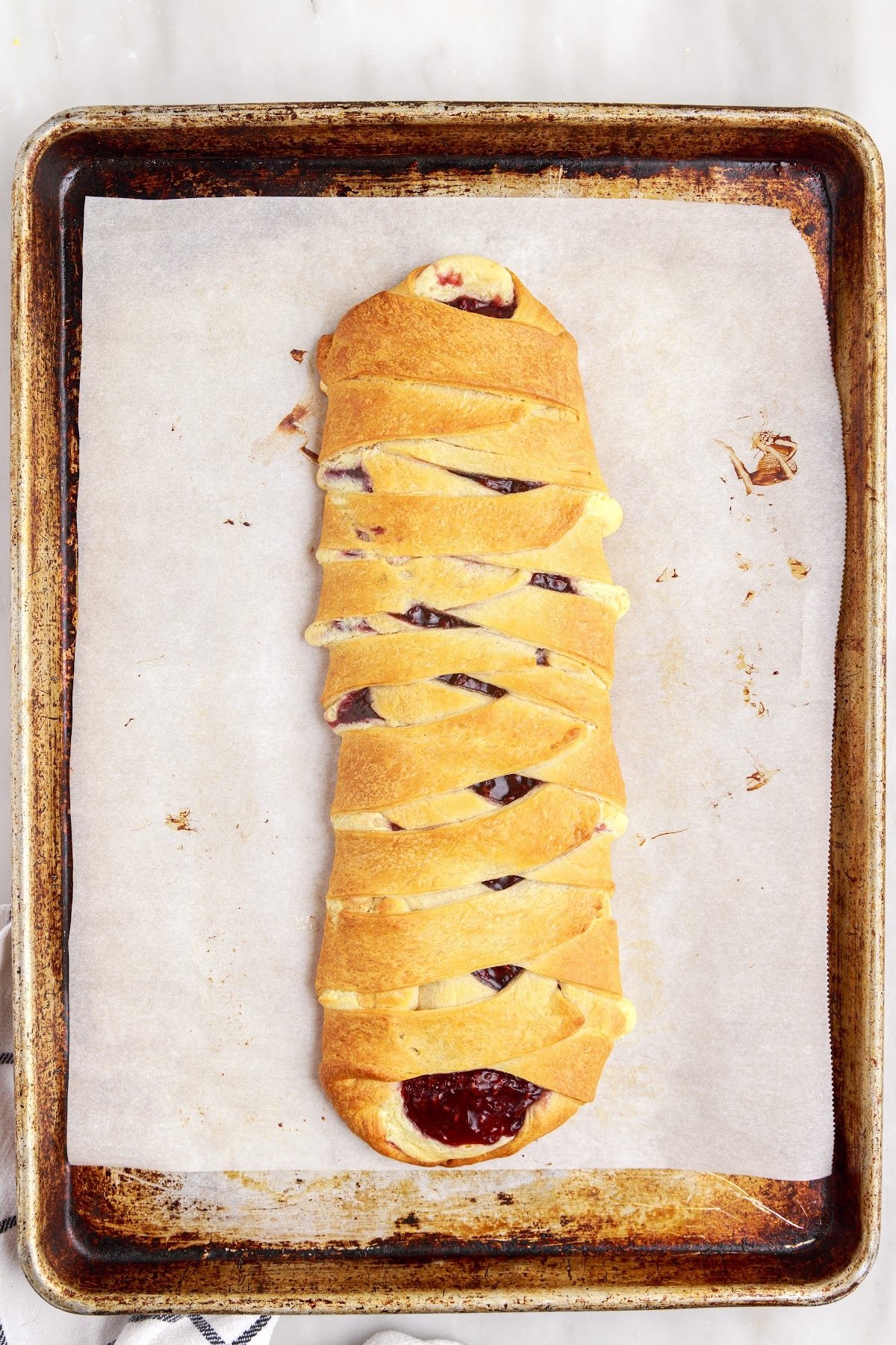 Fully baked crescent roll filled with cream cheese mixture and raspberry pie filling.