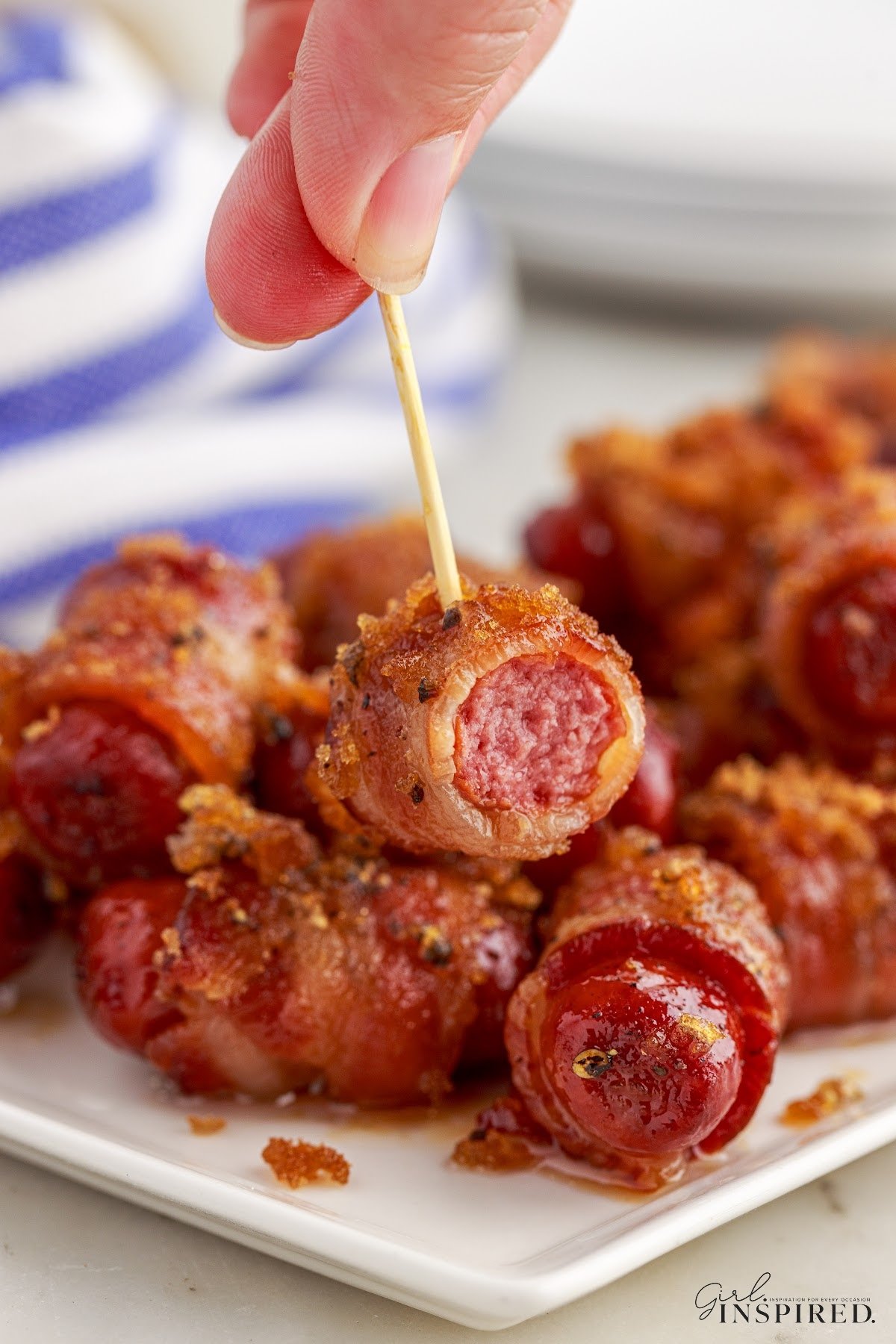 A platter of Bacon Wrapped Little Smokies and one on a toothpick.