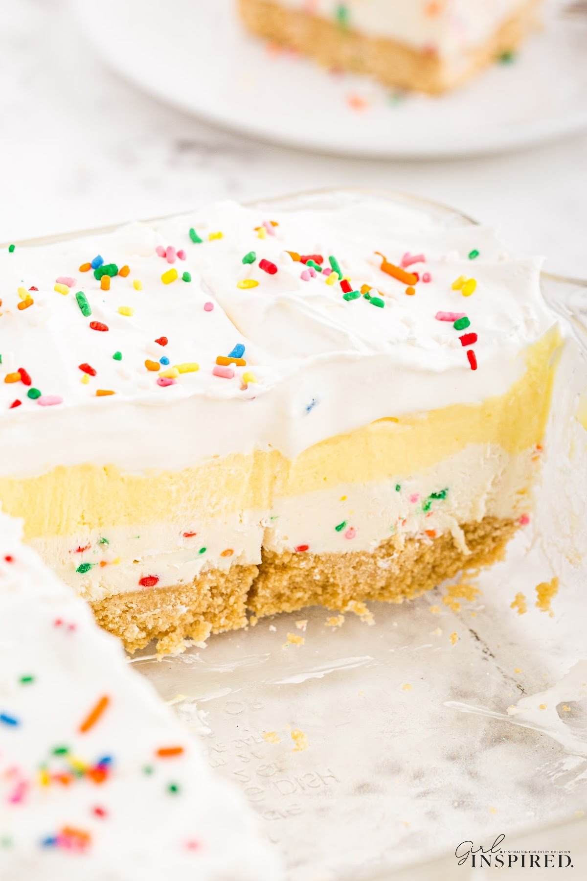 Large slices of birthday cake cheesecake bars showing the layers.