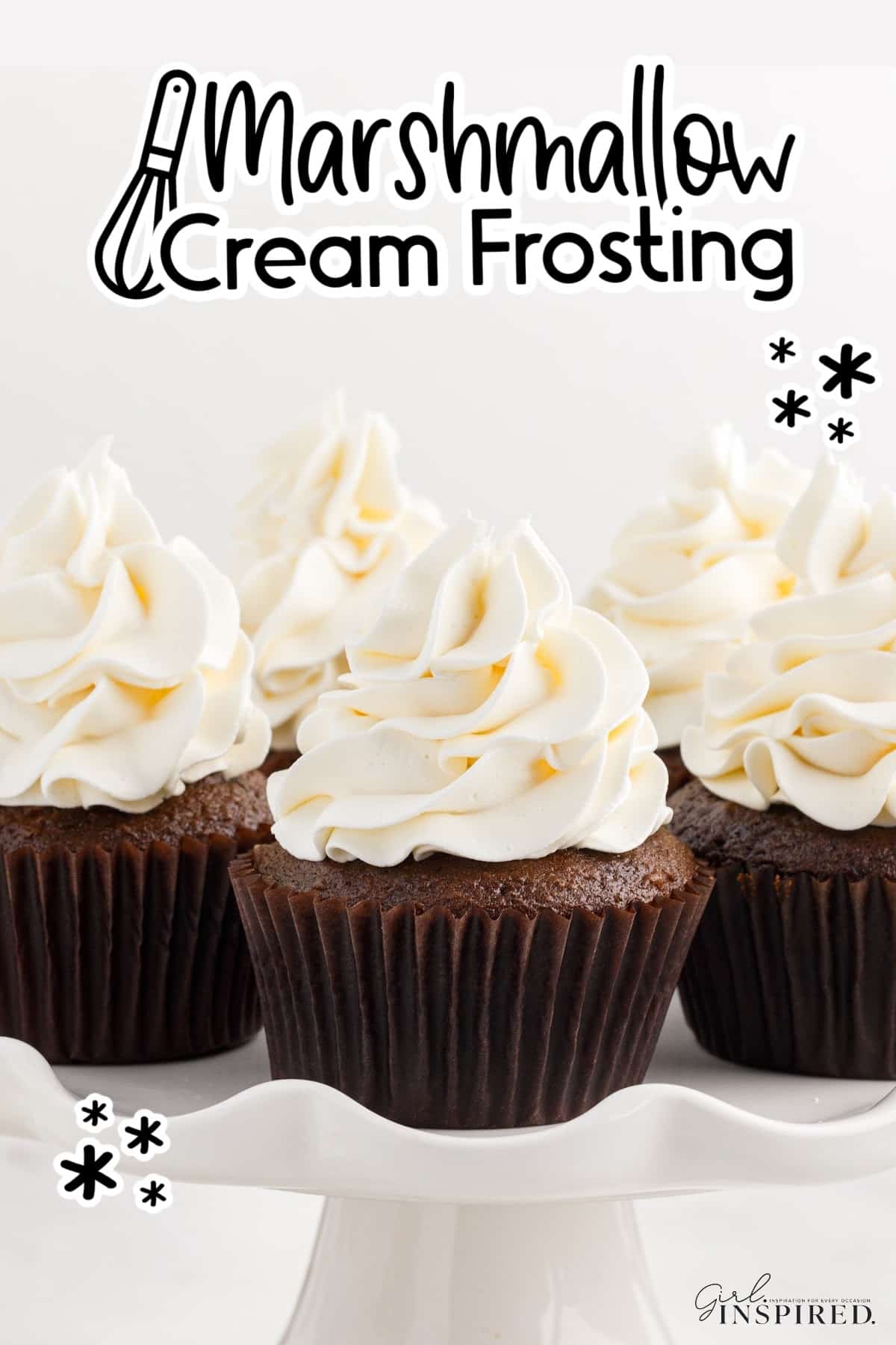 Cupcakes with Marshmallow Cream Frosting on them on a cake platter with text overlay.