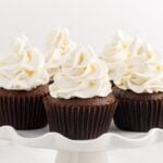 Close up of a cake platter full of cupcakes topped with Marshmallow Cream Frosting.