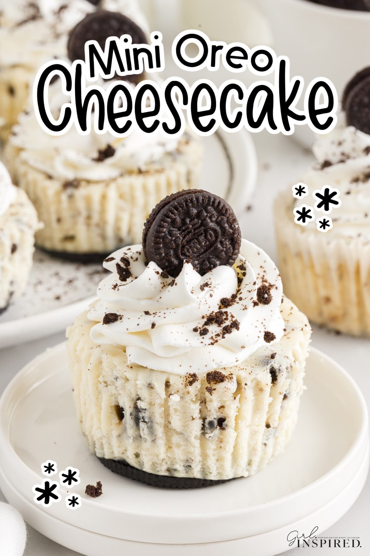 Mini Oreo Cheesecake on a plate topped with whipped cream and an oreo cookie, with text overlay.