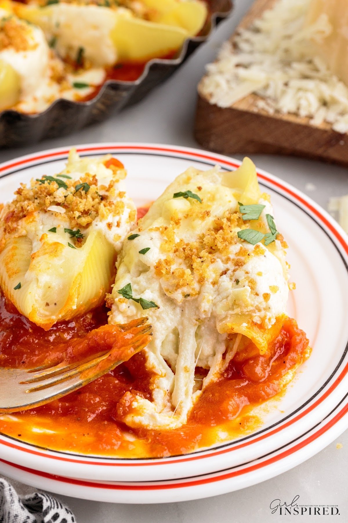 Giant Cheese Stuffed Shells olive garden copycat recipe is platted with shells in a marinara sauce.