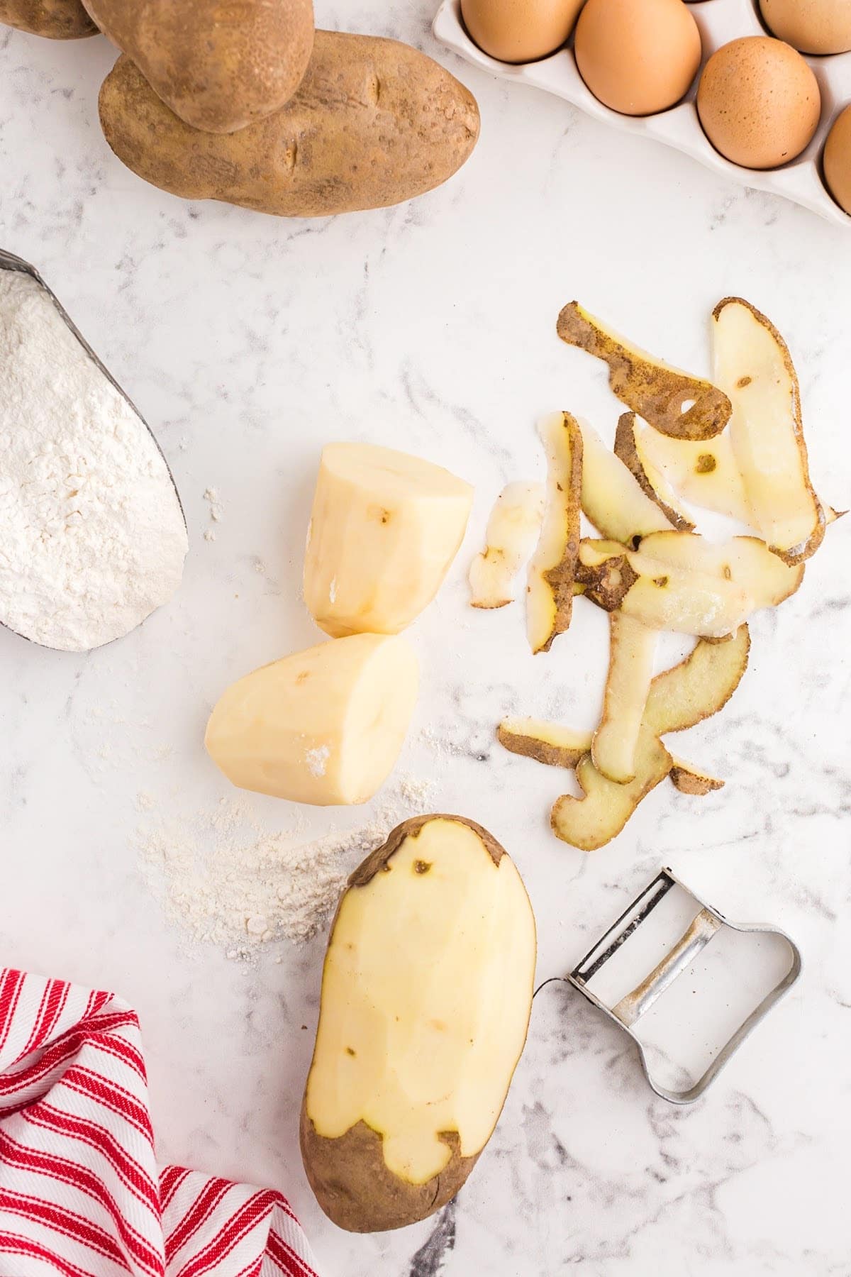 Peeling baking potatoes.