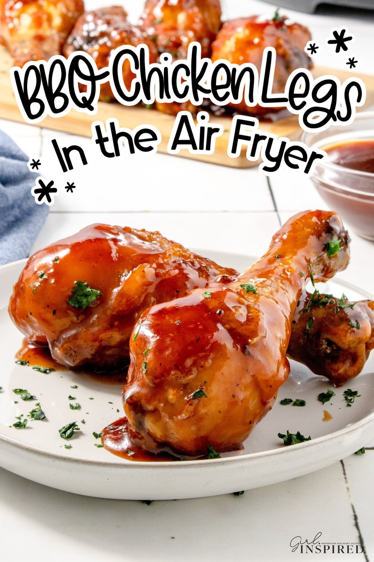 Two pieces of BBQ chicken Legs in air Fryer on a plate, with text overlay.