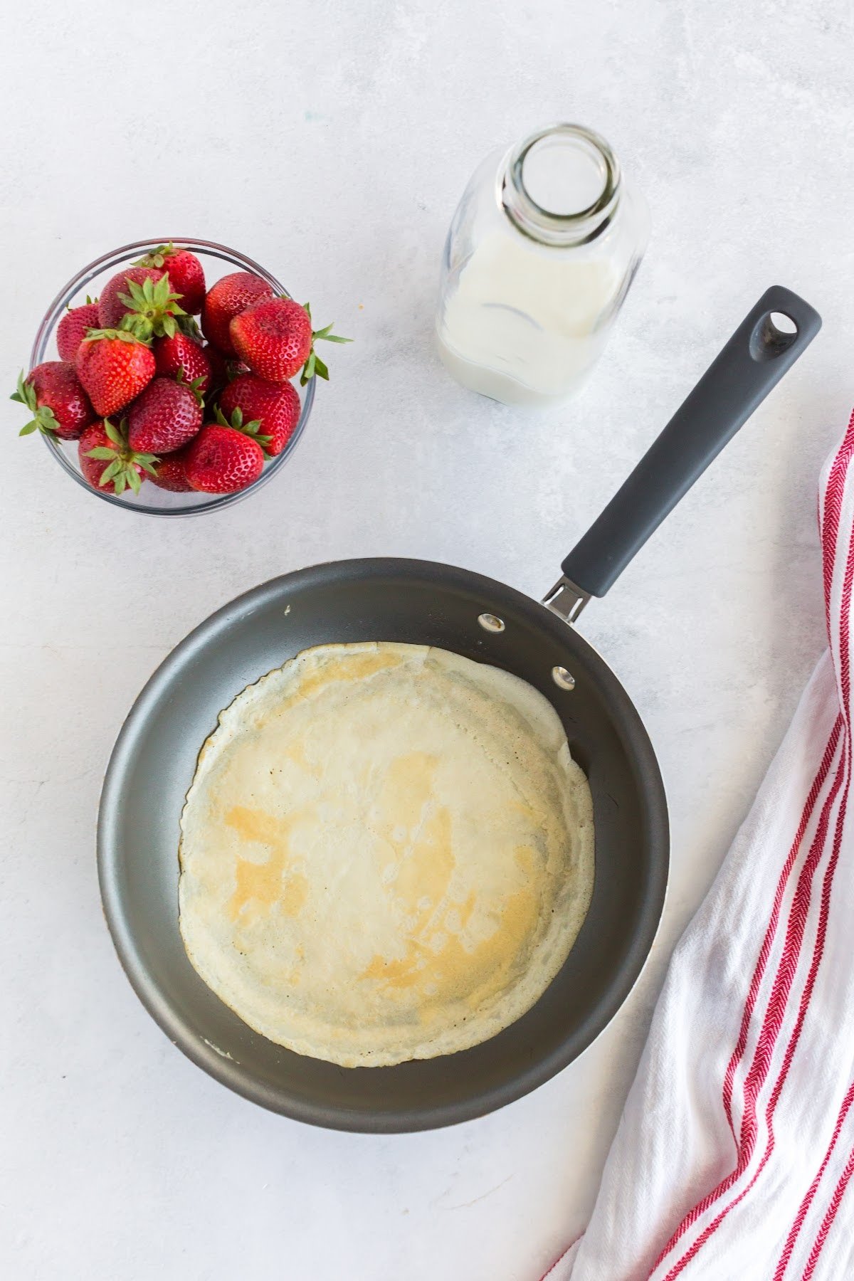 Flipping the breakfast crepe over.