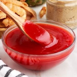 Bowl of Sweet and Sour Sauce, with a spoon scooping some out.