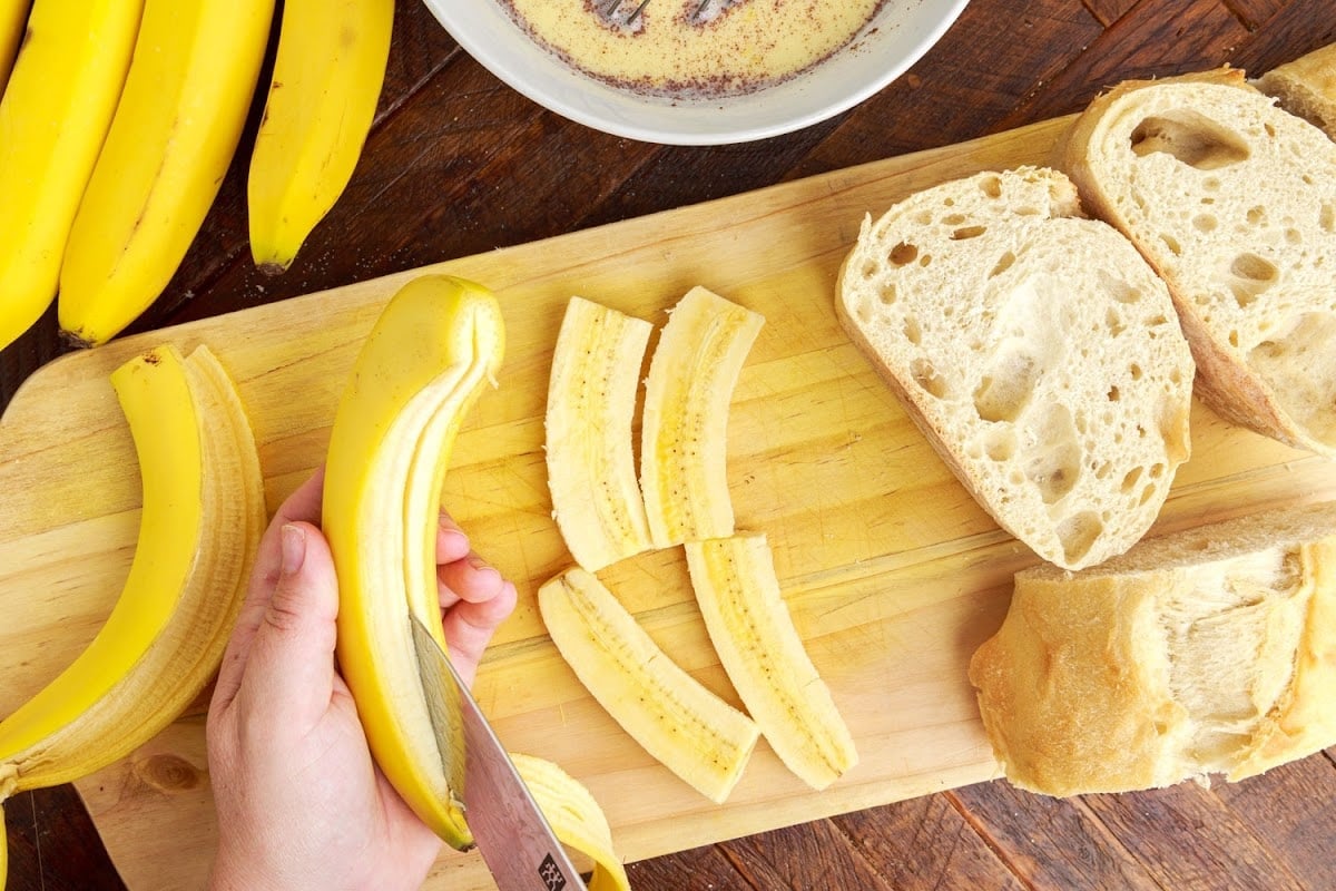 Cutting the bananas into long slices.