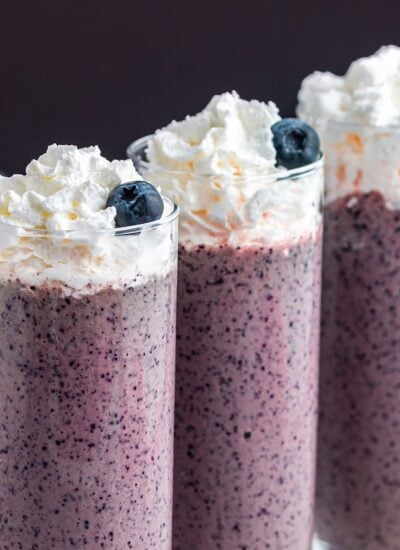 Blueberry Kale Smoothie garnished with whipped cream.