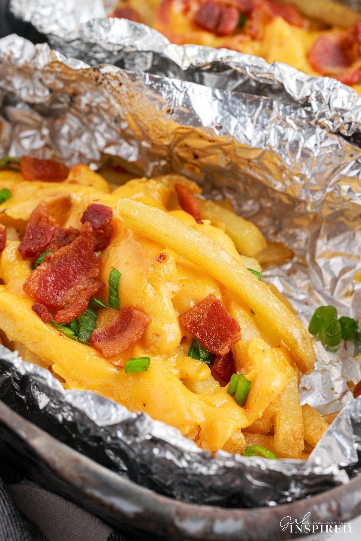 Dirty Fries in tin foil bowls fully loaded.