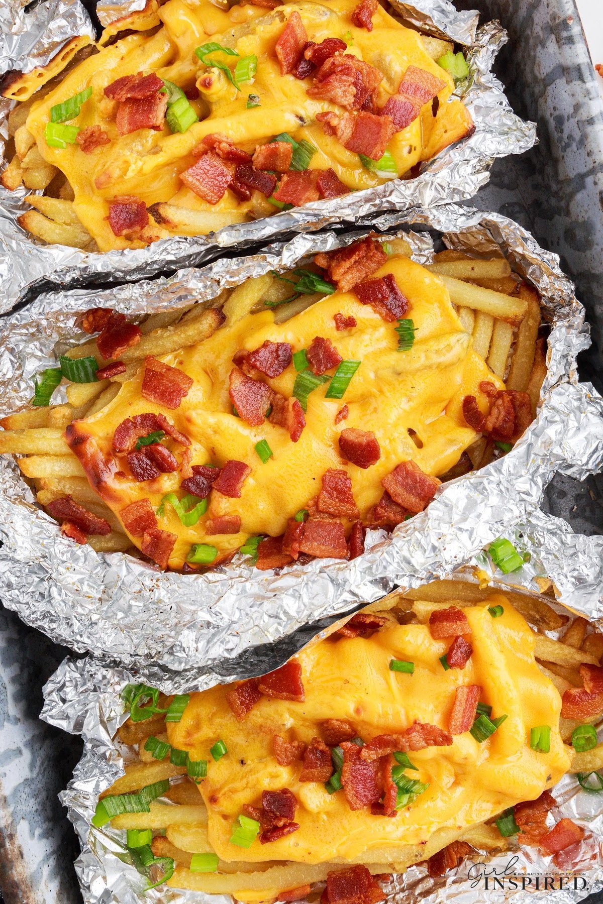 Dirty Fries in tin foil bowls fully loaded.