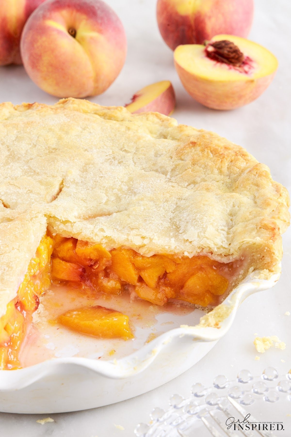 Fresh Peach Pie, with a slice removed so you can see the insides.