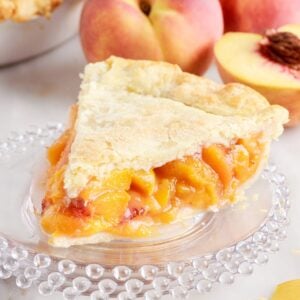 Since of Fresh Peach Pie on a plate.