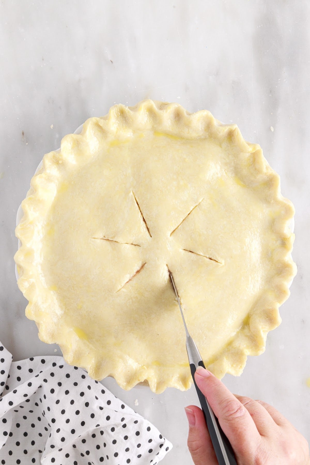 Cut slits on the top of the pie crust.