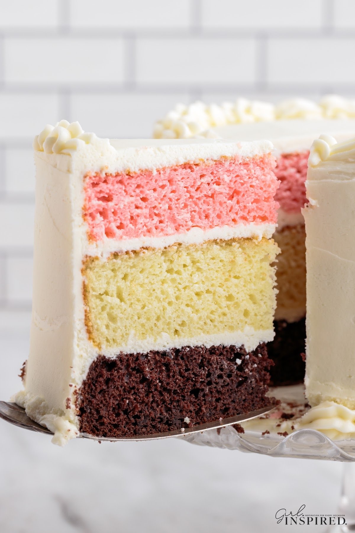 Slice of Neapolitan Cake on a plate ready to eat.