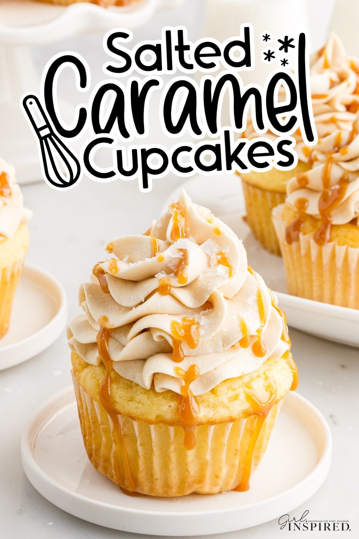 Salted Caramel Cupcakes on a plate, drizzled with caramel over the frosting, with text overlay.
