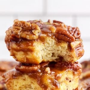 Close up of caramel pecan cinnamon rolls with a bite taken out.