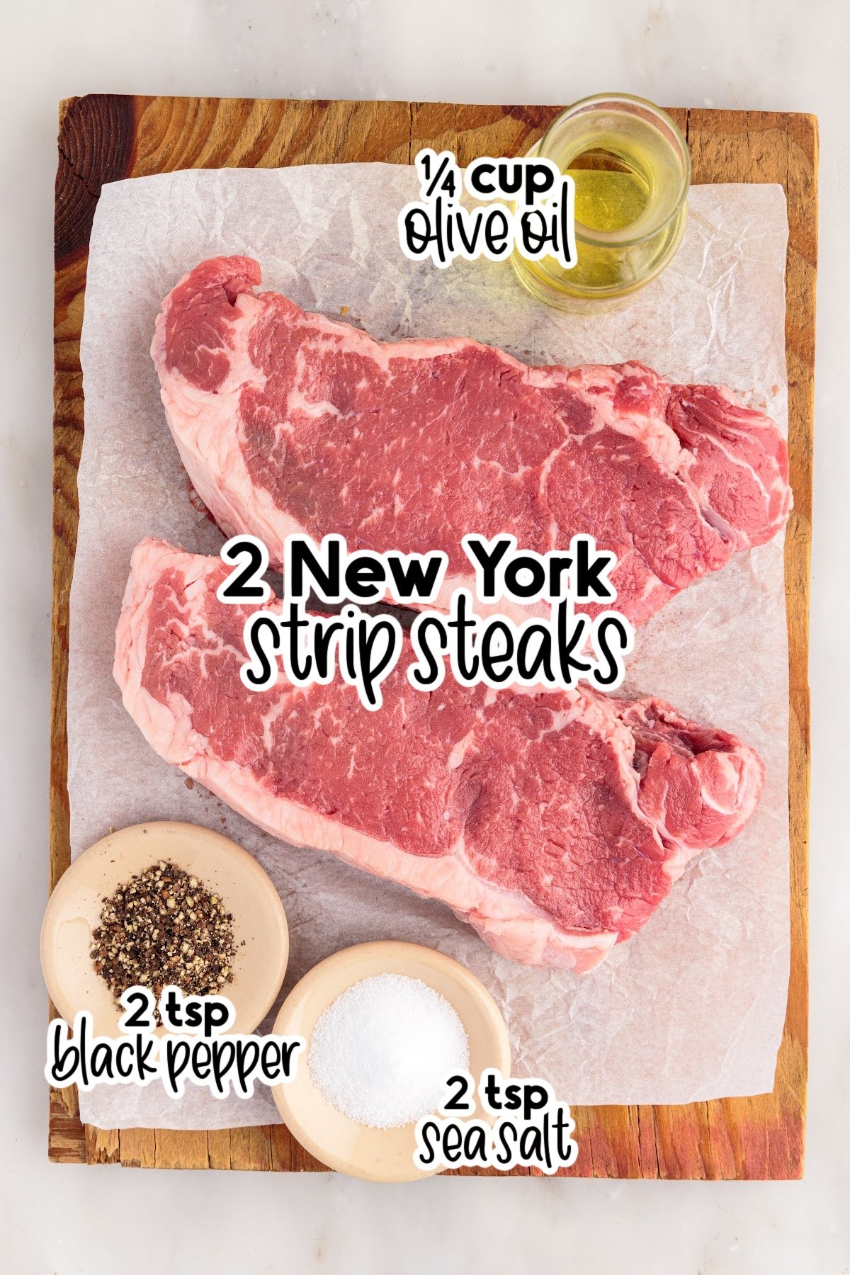 Ingredients needed to make grilled New York strip steaks.