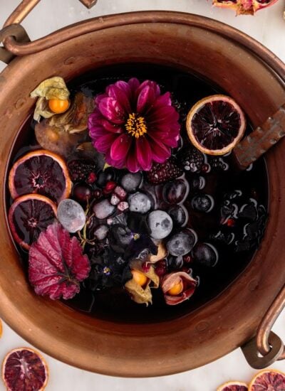 Halloween sangria with flowers, herbs, and fruit.