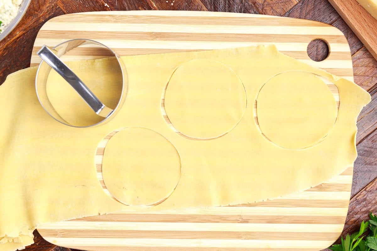 Cutting circles into the dough for the start of the tortellini forming.