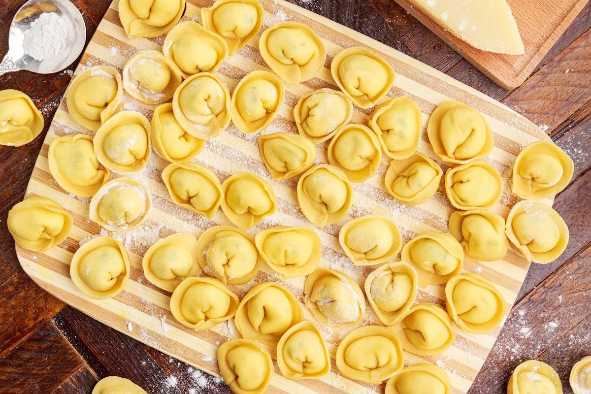 Cooked Tortellini on a cutting board.