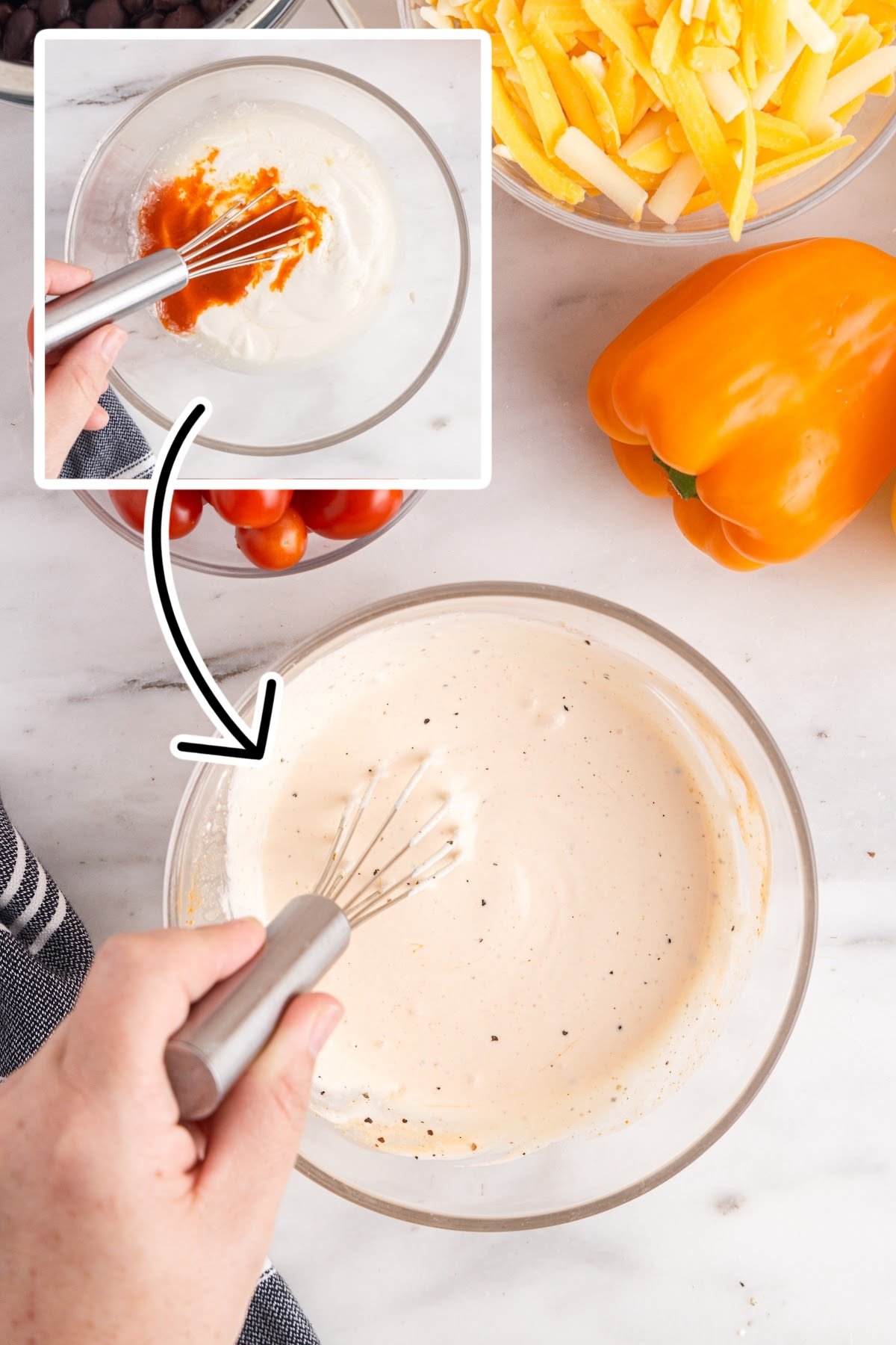 Whisking the layered Mexican salad dressing together in a glass bowl.