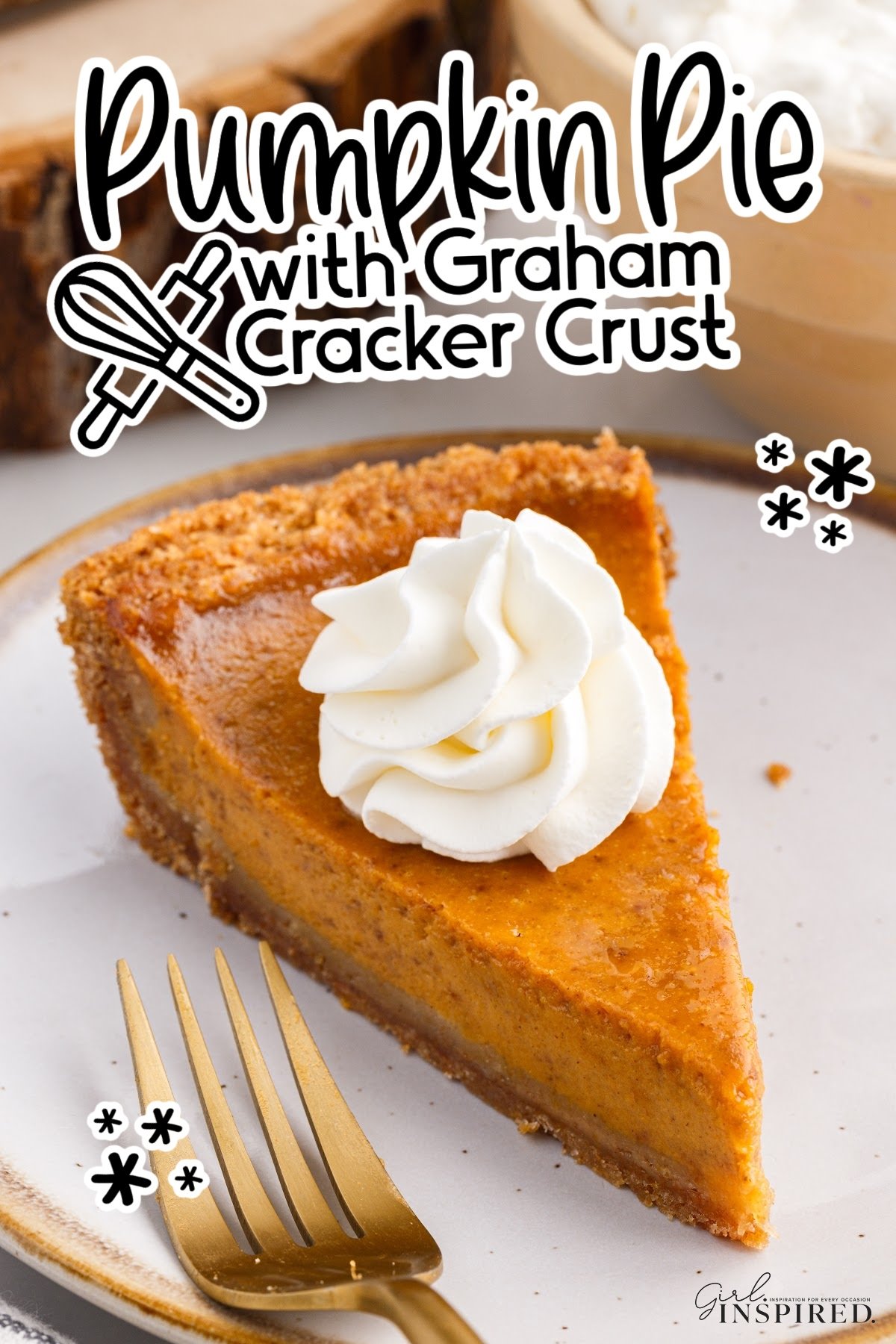 Pumpkin pie slice with a graham cracker crust topped with whipped cream.