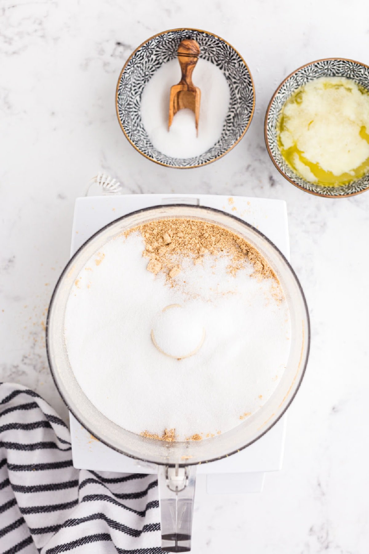 Sugar and graham cracker crumbs in a food processor.