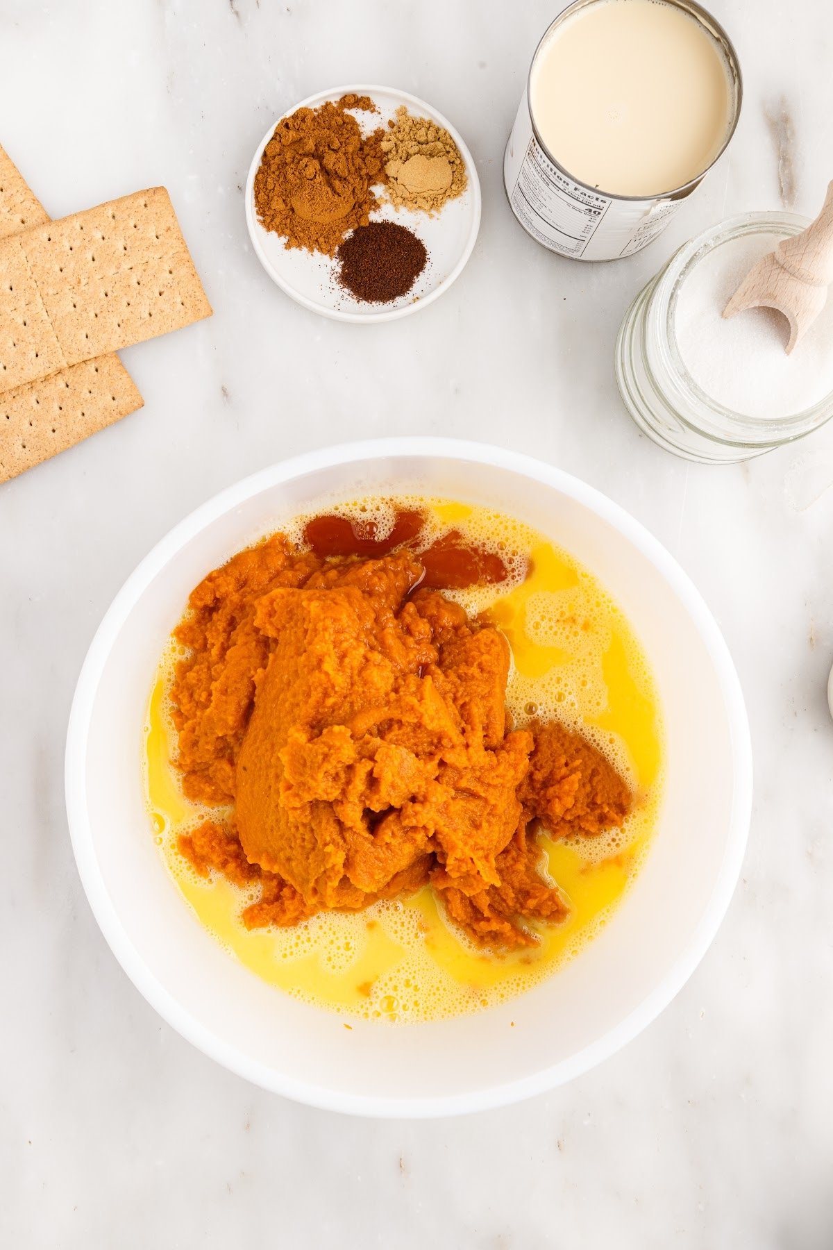 Adding the pumpkin puree to the beaten eggs.