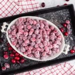 Bowl of Sugared Cranberries, on a baking sheet.