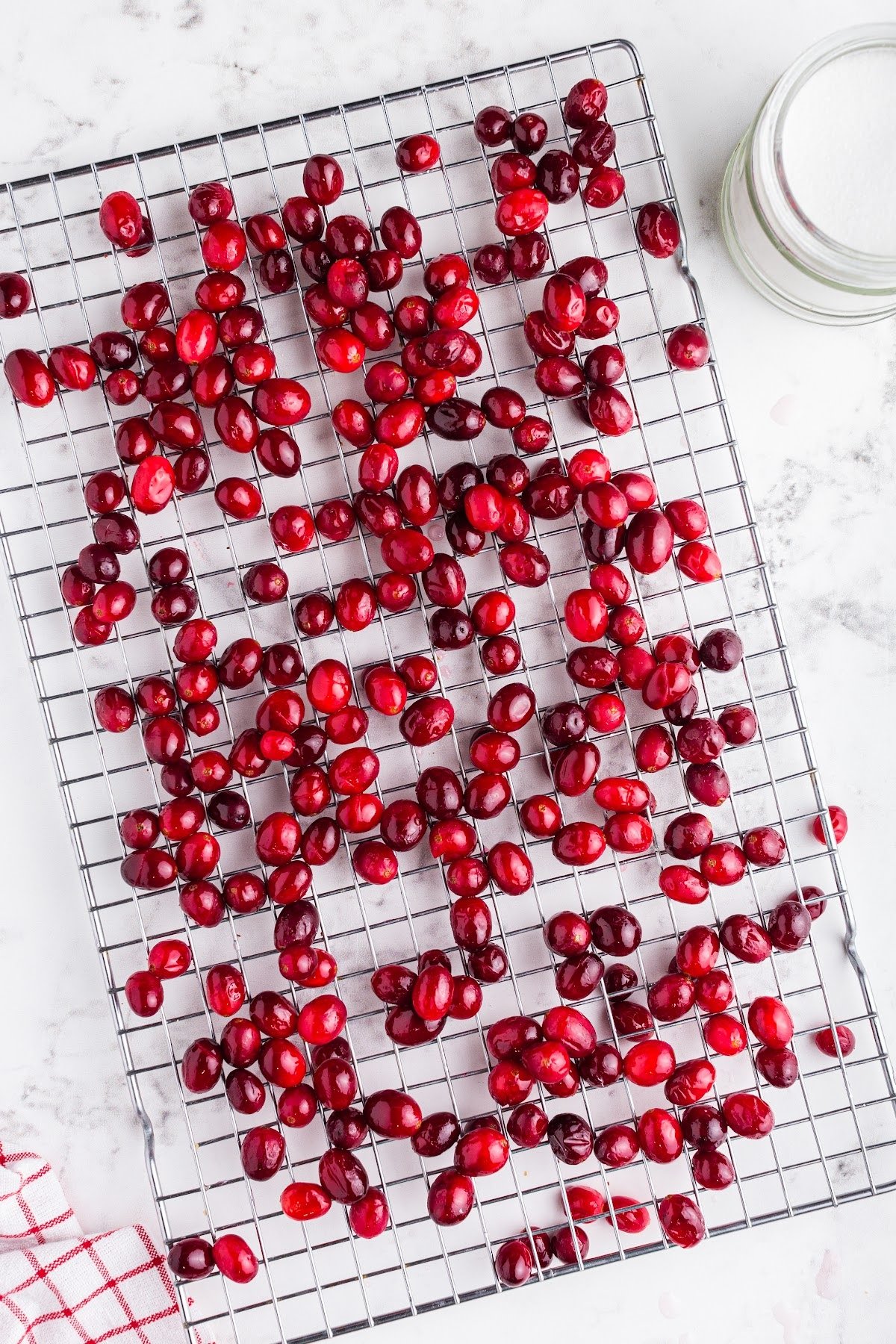 Cranberries drying on a wire rack.