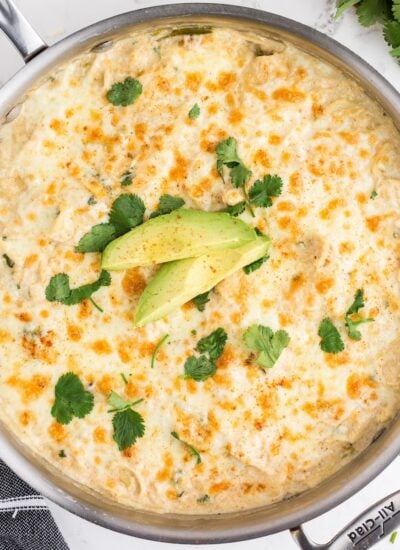 Skillet filled with White Chicken Enchilada Casserole.