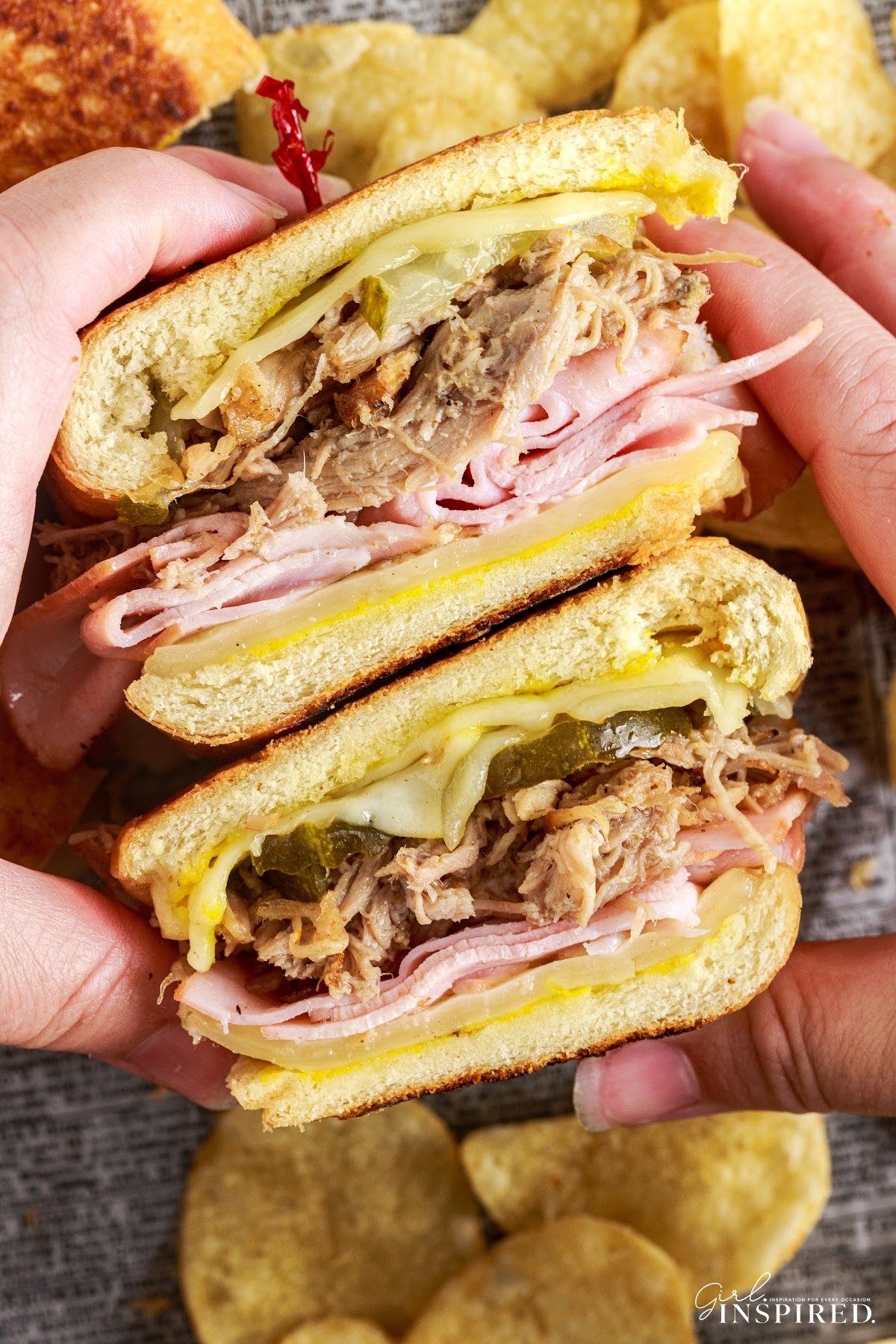 Cheesecake Factory Cuban Sandwich sliced in half so you can see the ingredients inside.