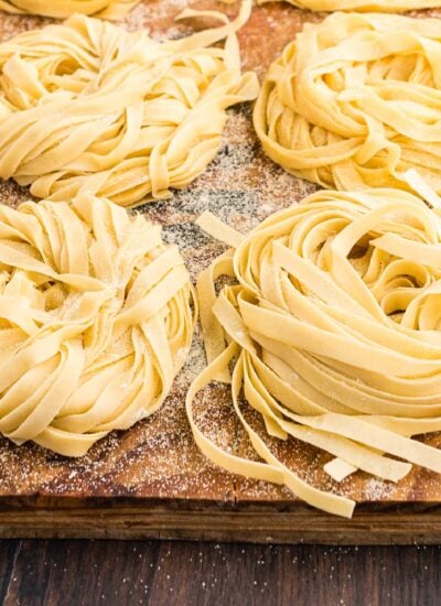 Six rolls of How to Make Homemade pasta on a baking sheet.