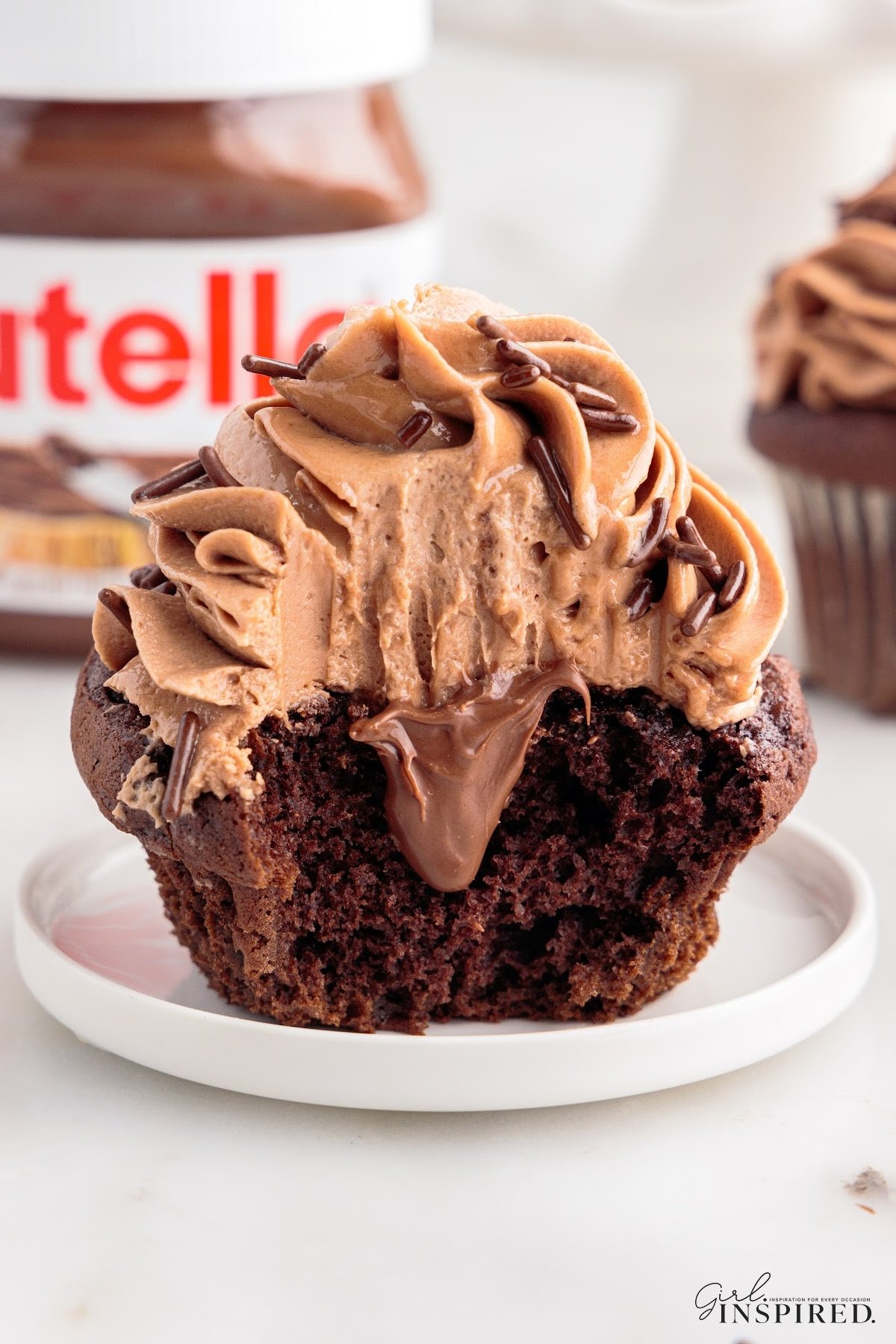 Cut in half Nutella Cupcake, showing the inside filling and frosting.