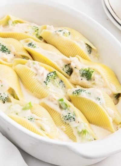 A platter filled with Chicken Alfredo Stuffed Shells.