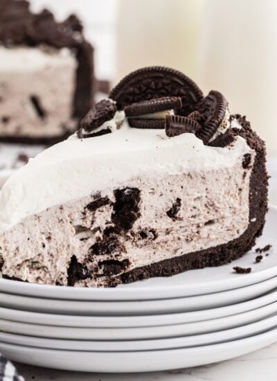 Slice of No bake Oreo Cheesecake, with cookies on top.