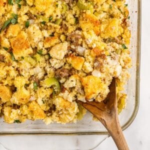 Close up of a spoon filled with Cornbread Sausage Stuffing.