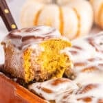 A slice of Pumpkin Spice Cinnamon Rolls on a plate, showing the inside.