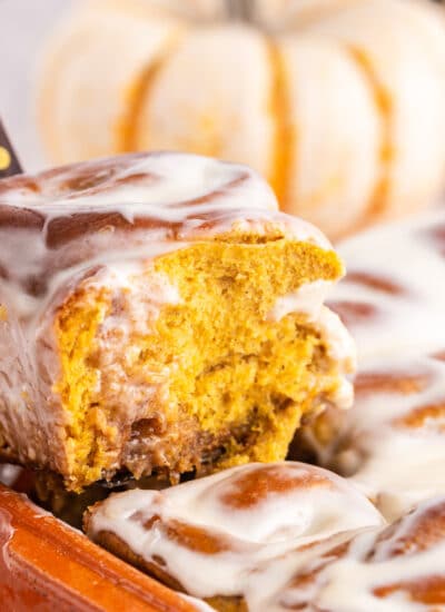 A slice of Pumpkin Spice Cinnamon Rolls on a plate, showing the inside.